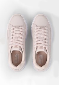Light pink athletic shoes with a smooth synthetic upper, white sole, round toe, and central lacing system; features FILA logo on tongue.