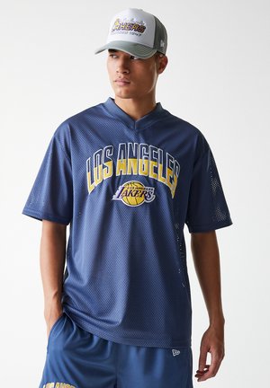 Navy mesh jersey with "LOS ANGELES LAKERS" in yellow and white lettering, paired with matching shorts. Gray cap with embroidered logo.