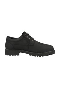 Zapatos de cuero negros con puntera redondeada, diseño de cordones y suela de goma texturizada con surcos profundos. Un pespunte en contraste realza el borde.