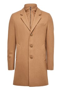 Kamelfärgad ullrock med slagkrage, tre framknappar och en bröstficka. Slät textur med sidofickor och en zip-krage.