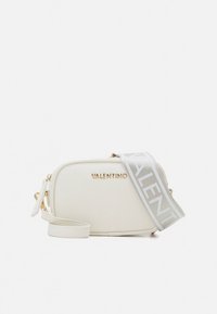 White leather crossbody bag with gold logo, zip closure, and adjustable gray strap featuring repeating logo pattern. Smooth texture.