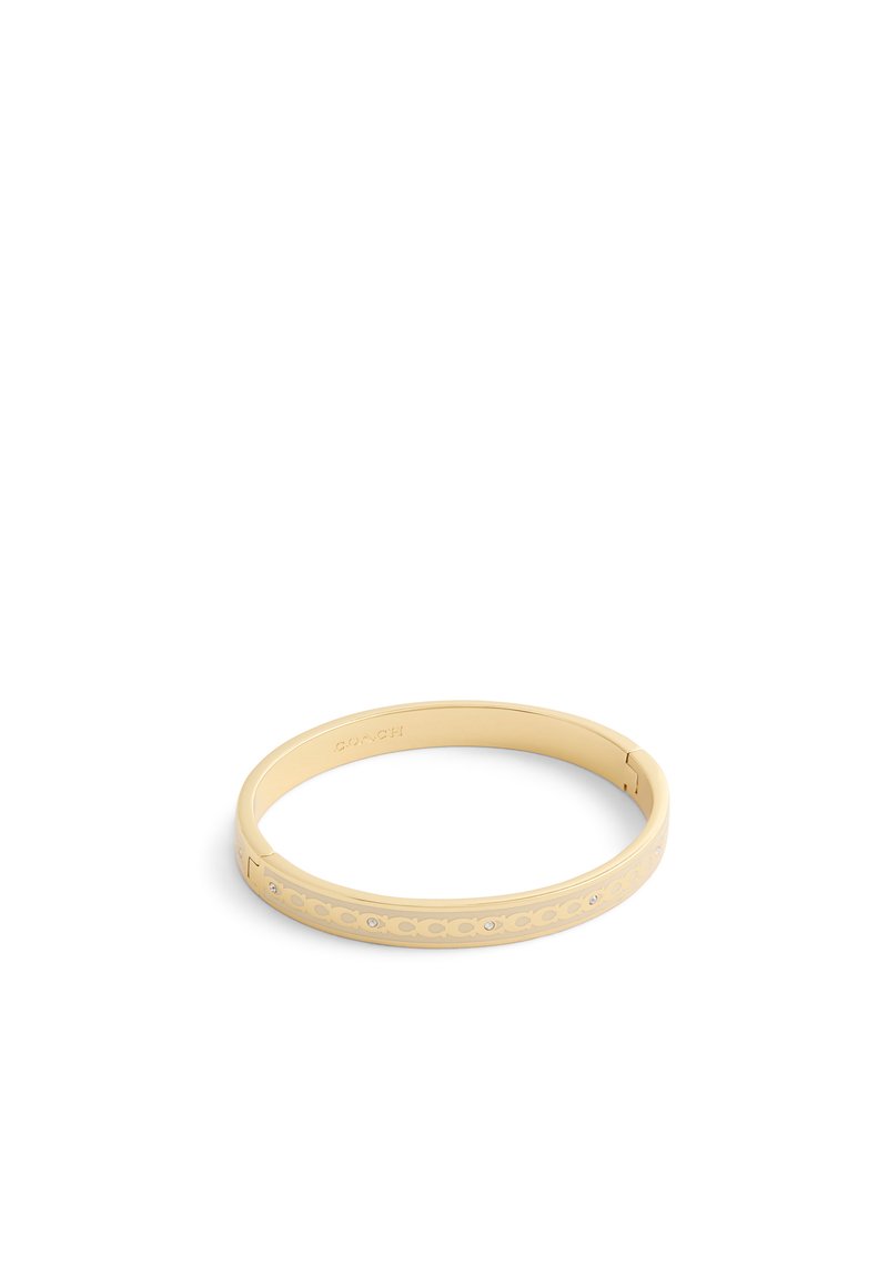 Gold-colored bangle bracelet features a smooth surface with cut-out patterns and embedded rhinestones, creating a contemporary design.