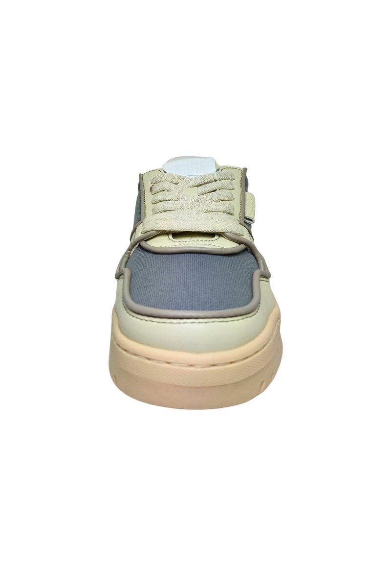 Sneaker with a gray canvas upper, cream leather accents, lace-up front, and beige rubber sole. Features textured detailing on the tongue.
