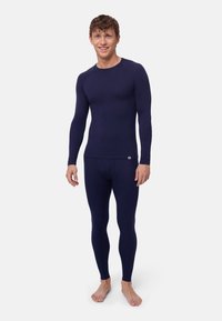 Dunkelblaues Langarm-Baselayer und enganliegende Leggings aus weichem, dehnbarem Material. Glatte Oberfläche ohne sichtbare Muster oder Akzente.