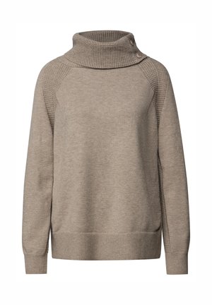 Beige tröja med hög krage, som har en texturerad övre del och en slät kropp. Inkluderar sidoknappar och ribbade manschetter och fåll.