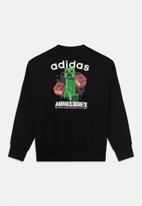 Schwarzer Sweatshirt mit langen Ärmeln. Auf der Rückseite ist ein Grafik eines Minecraft Creepers abgebildet, der TNT hält, mit dem Text "adidas" und "Minecraft".