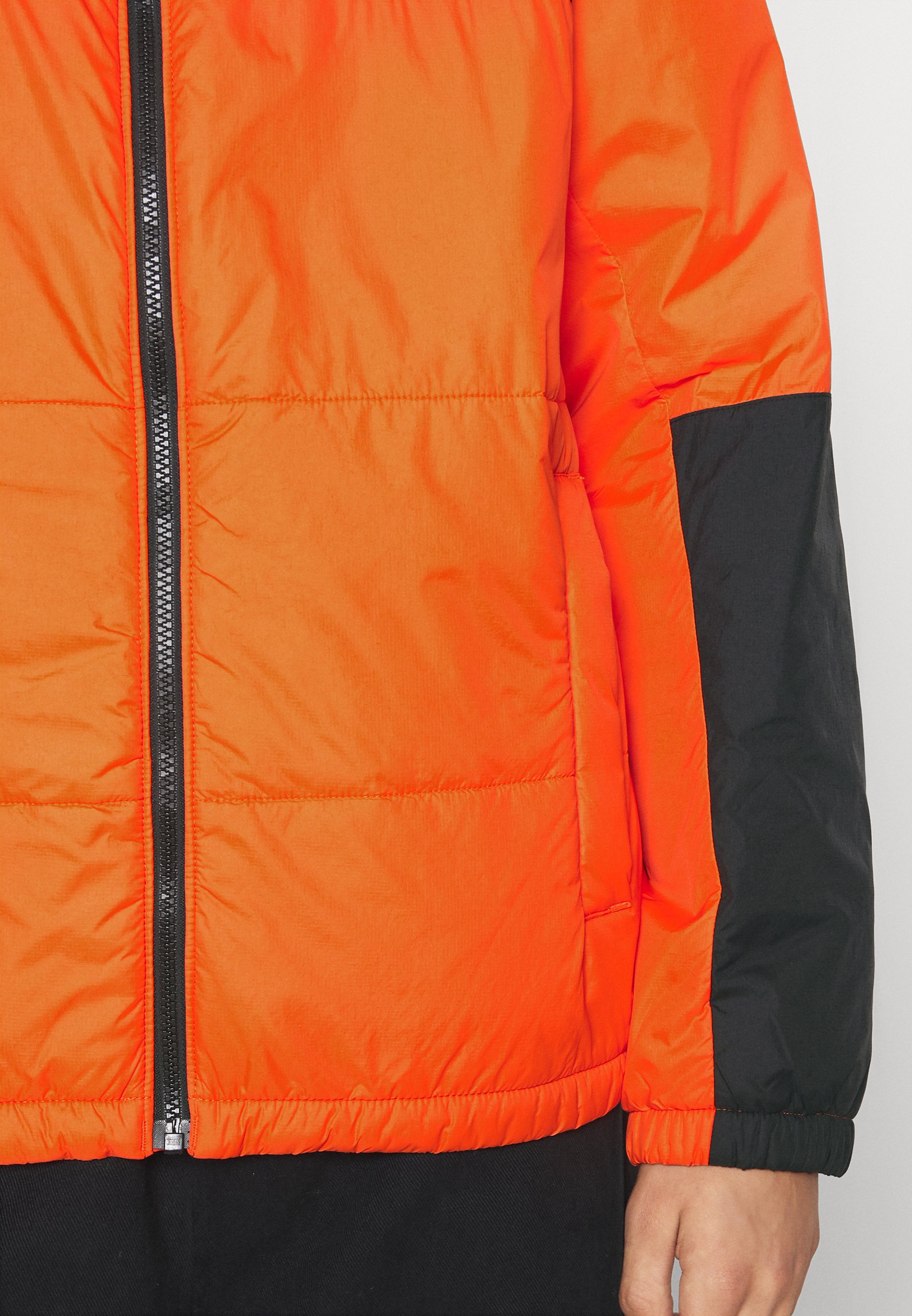 black and orange puffer jacket