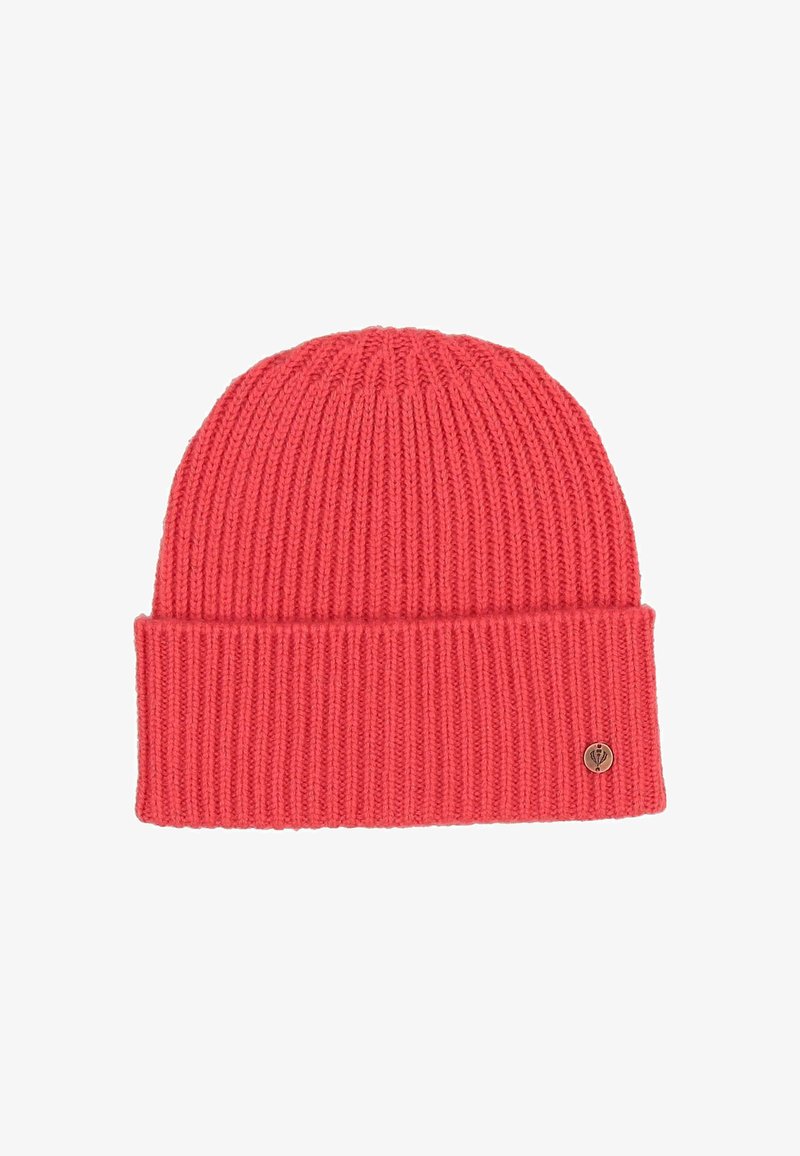 Red ribbed knit beanie hat with folded cuff and small round metal logo badge on the cuff’s right side.