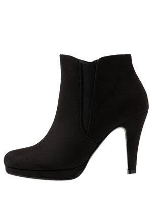Black ankle boot with a pointed toe, high heel, and soft suede-like texture. Features elastic side panels and a smooth silhouette.