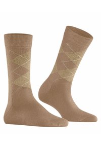 Calzini marroni con un motivo argyle a rombi in oro con dettagli bianchi. Realizzati in materiale morbido, hanno polsini a coste per maggiore comfort.