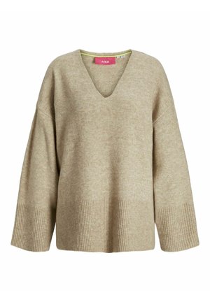 Beige genser med V-hals og vide ermer. Har ribbestrikkede mansjetter og hem, laget av et mykt, teksturert stoff.