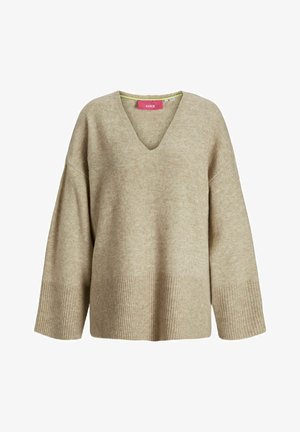 Pull en beige avec un col en V et des manches larges. Présente des poignets et un ourlet côtelés, confectionné dans un tissu doux et texturé.