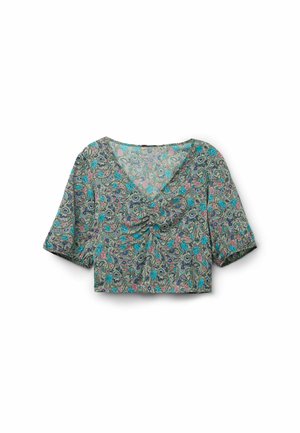 Chemise courte en tissu léger avec un motif floral paisley turquoise, rose et noir. Elle possède un col en V et des manches courtes.