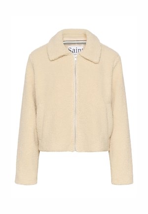 Gekorte jas met ritssluiting aan de voorkant in crème-kleurig nepbont met een zachte textuur, puntige kraag en zijzakken. Heeft een eenvoudig, onversierd ontwerp.