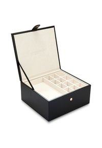 Black leather jewelry box with a beige suede interior, featuring multiple compartments and a gold clasp detail. Lid opens vertically.