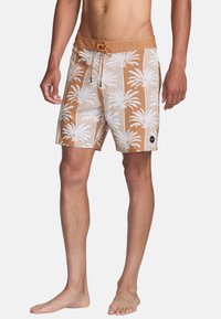 Light brown swim shorts with white palm tree pattern, elastic waistband, adjustable drawstring, and side pockets. Fabric appears smooth and flexible.