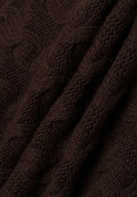 Braun gestrickter Stoff mit einem strukturierten Zopf-Muster; weiche, flauschige Oberfläche; drapiert, um Tiefe und Webdetails zu zeigen.