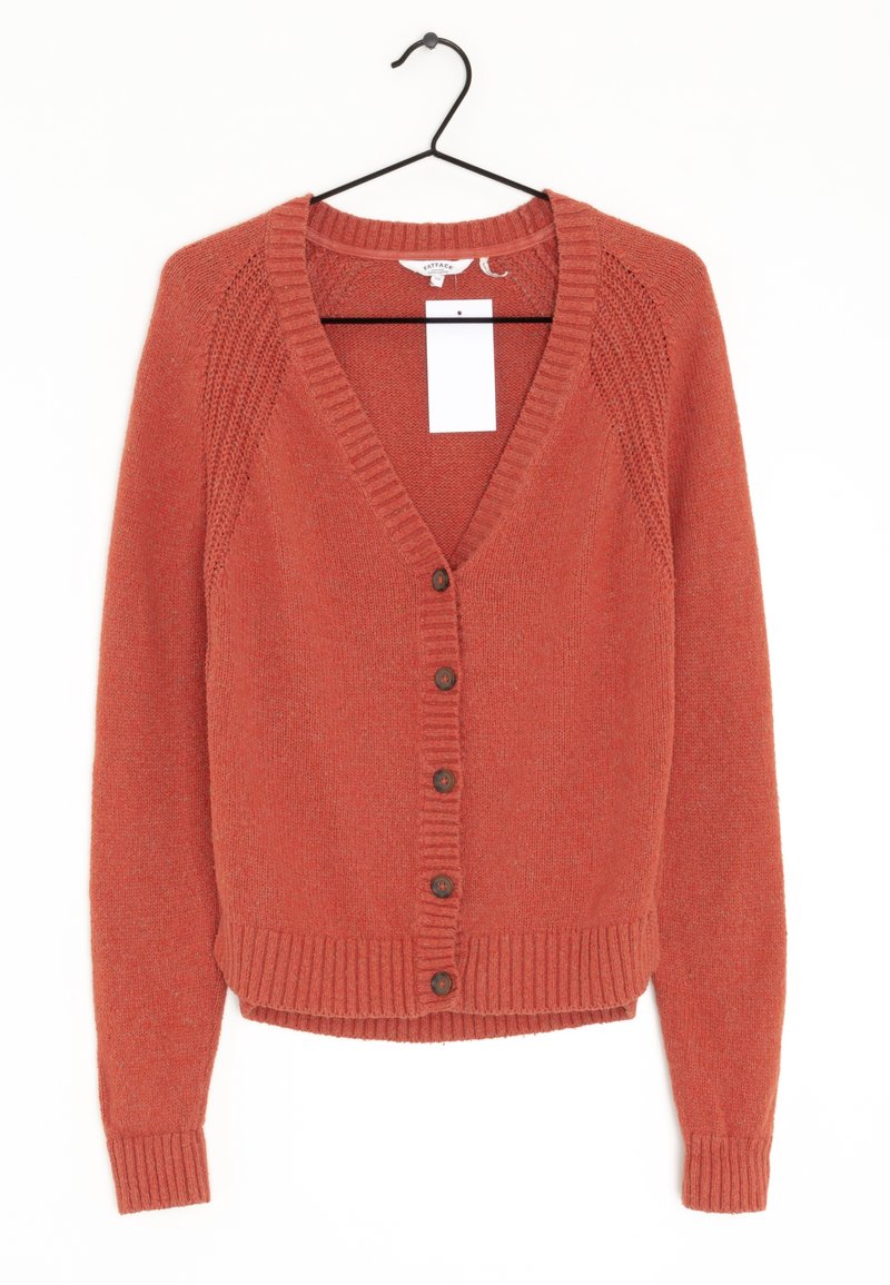 Rust-colored knitted cardigan with long sleeves, button front, and ribbed cuffs and hem, hanging on black hanger with white tag.