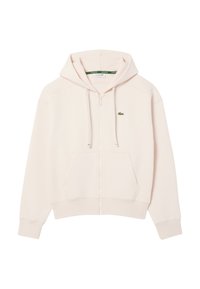 Sudadera con cremallera de color rosa claro, hecha de tejido suave, con un bolsillo delantero y un logo verde de Lacoste en el pecho. Capucha ajustable con cordón.