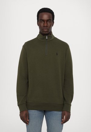 Olive green zip-up sweatshirt with a high collar, long sleeves, ribbed cuffs, and a small black logo on the left chest.