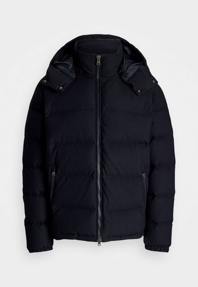 Navy puffer jacket with a high collar and detachable hood. Features a full front zip, side pockets, and a quilted texture.