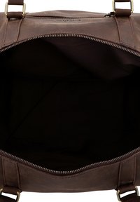 Brown leather bag with a zippered opening, showing a spacious, dark fabric interior. Features sturdy straps and a smooth texture.