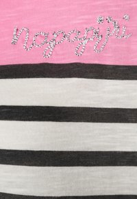 Short-sleeve striped shirt with pink, white, and black colors; features embroidered logo "napapijri" in silver thread. Soft, textured fabric.