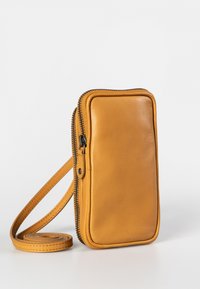 Yellow leather crossbody bag with a smooth texture, zip closure, and flat design. Features a long, rolled strap for carrying convenience.