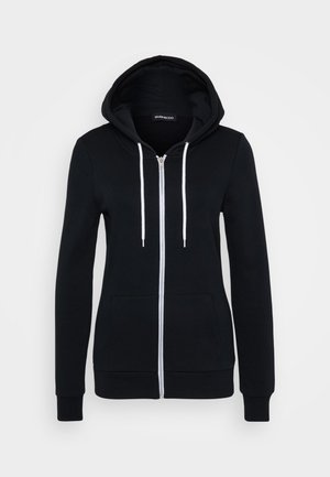 Svart zip-up hettegenser med hvite snorer, lange ermer og en frontlomme. Laget av mykt stoff med en jevn tekstur.