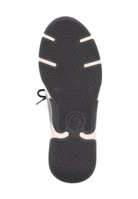 Black rubber shoe sole with a textured, geometric pattern. Light-colored accents along the edges and a logo in the center.