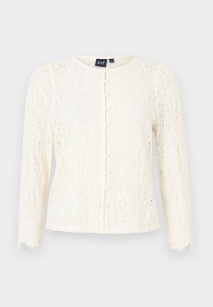 Lace cardigan in off-white with long sleeves, round neckline, and pearl button closures. Features intricate lace pattern and frayed sleeve edges.
