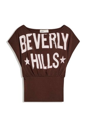 Brown short-sleeve top with wide neckline and elastic waist, featuring large white "BEVERLY HILLS" text and star graphics on front.