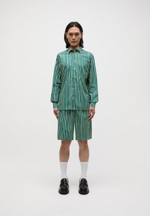 Green vertical striped shirt and matching shorts, made of smooth fabric. Worn with black shoes and white crew-length socks. Simple buttons.