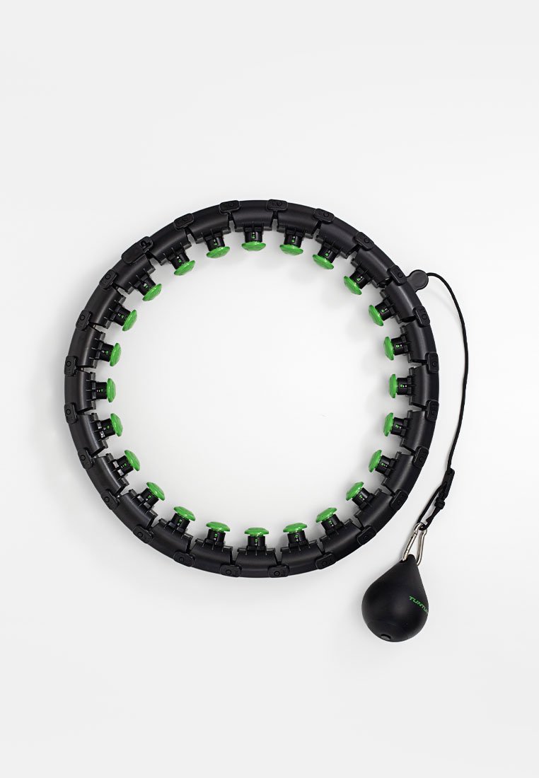 Zwarte ronde fitnesshoepel met groene accenten, gemaakt van plastic, met verstelbare segmenten en een zwarte gewrichtszak bevestigd met een touw.