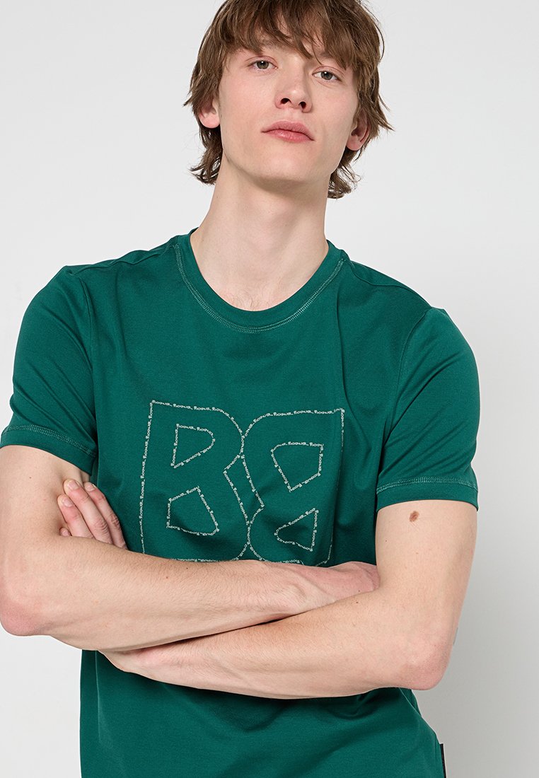 Grünes Baumwoll-T-Shirt mit großem gesticktem "BG"-Logo auf der Vorderseite, rundem Halsausschnitt und kurzen Ärmeln mit glatter Textur.