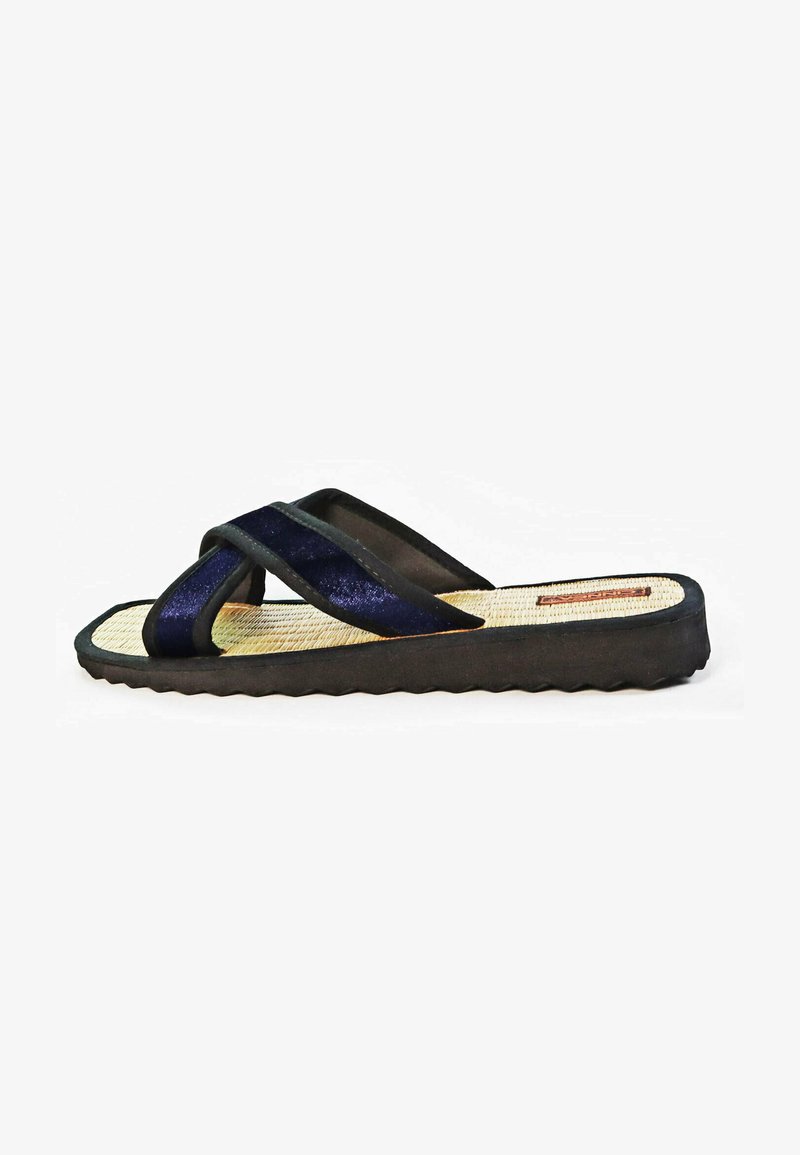 Black and navy blue flip-flop with cross straps, textured sole, and woven insole. Features a zigzagged outsole for traction.