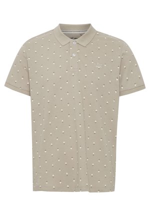 Jasnokremowa koszulka polo z bawełny, z teksturowanym wzorem małych diamentów w białym i brązowym kolorze. Zapięcie na trzy guziki.