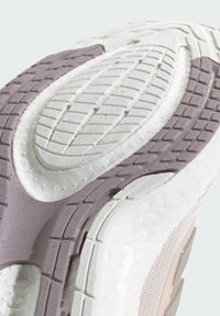Sneaker outsole with textured white and lavender rubber, featuring deep tread patterns and a cushioned, raised midsole design.