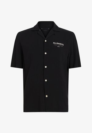 Lühikeste varrukatega must nööbiga särk, millel on mugav lõige, lihtne tekstuur ja valge tikandiga kaubamärgi nimi vasakul rinnal.