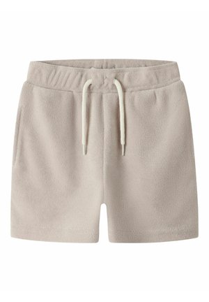 Shorts en éponge beige clair avec taille élastique, cordon blanc et poches latérales, conçus pour un usage décontracté.