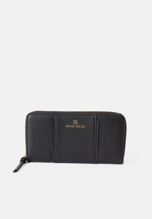 Black leather wallet with a textured surface, zip closure, and gold hardware. Features slots for cards and a logo detail on the front.