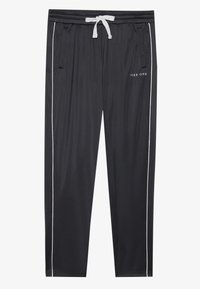 Black athletic pants with a drawstring waist, side pockets, and white stripes along the sides. Features a small logo on the front.
