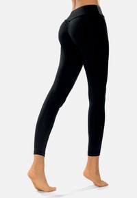 Hoge taille zwarte leggings van rekbaar materiaal, met een geplooid detail aan de achterkant en een snug fit, met broekspijpen tot de enkels.