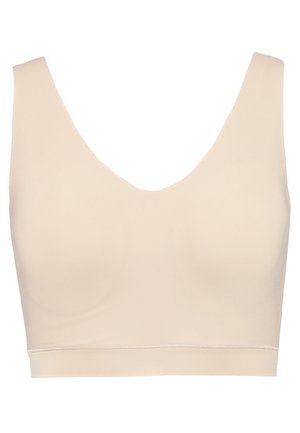 Light beige sports bra with a wide V-neckline, seamless design, smooth texture, and a solid color throughout. Offers medium support.