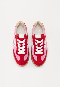 Sneakers in suede rosso e rosa con accenti bianchi, punta rotonda, lacci bianchi e suola in gomma texturizzata. Design atletico classico.