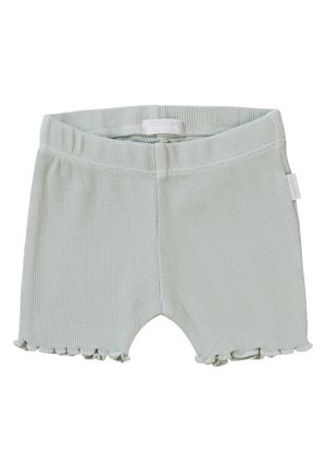 Hellgrüne gerippte Shorts mit einem Rüschensaum, ausgestattet mit einem elastischen Bund für Komfort und einem Etikett an der Seite.
