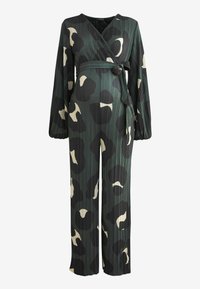 Combinaison plissée verte et noire à manches longues, design croisé et motif abstrait beige. Détail de taille nouée qui ajoute de la forme.