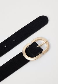 Black suede belt with a gold-tone metal buckle, featuring a smooth texture and multiple adjustment holes along its length.