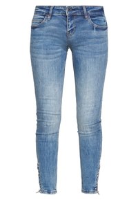 Světle modré skinny džíny z denimu s vybledlými oblastmi, předními kapsami a dekoračními bočními knoflíky na lemu. Klasický design s pěti kapsami.