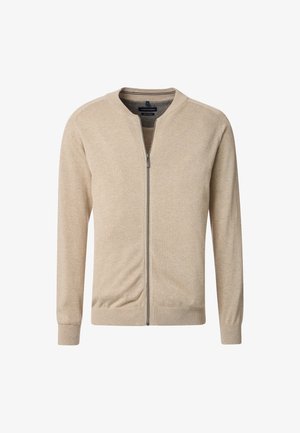 Beżowy kardigan na zamek wykonany z miękkiego materiału, z okrągłym dekoltem, długimi rękawami i subtelnymi prążkowanymi wykończeniami przy mankietach i dole.